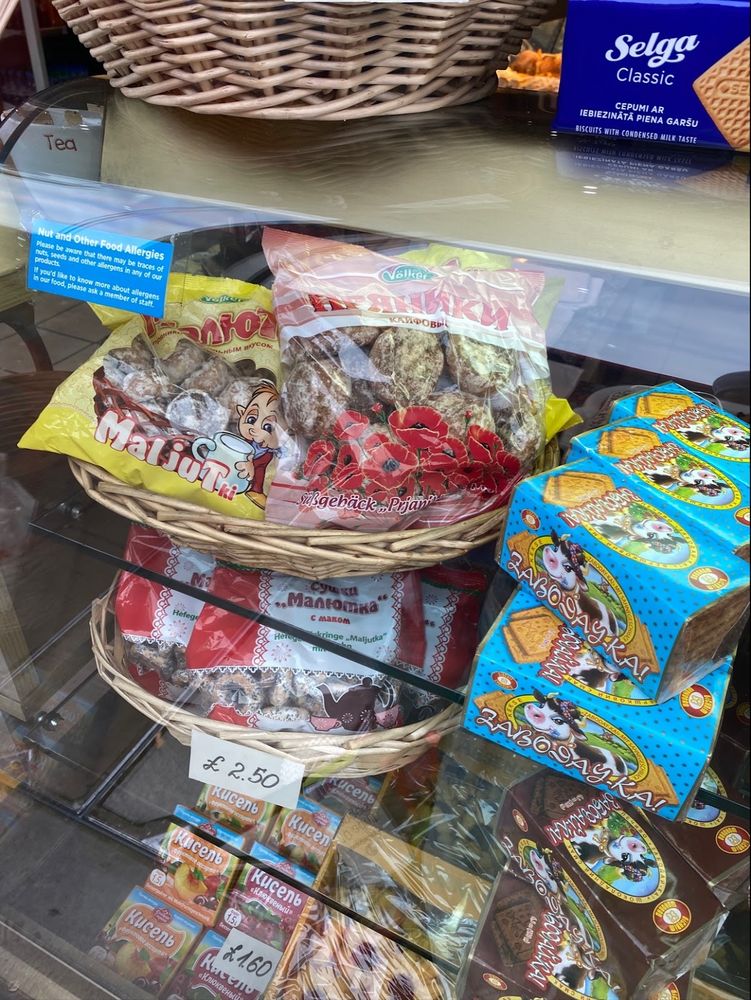 Shelves and baskets of packaged imported sweets, biscuits and confectionery in the shop